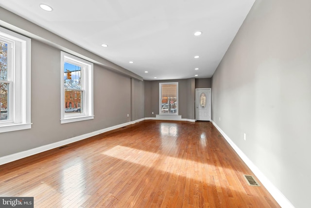 639 S Conkling St, Baltimore, MD 21224 - empty room featuring plenty of natural light, hardwood / wood-style flooring, baseboards, and recessed lighting
