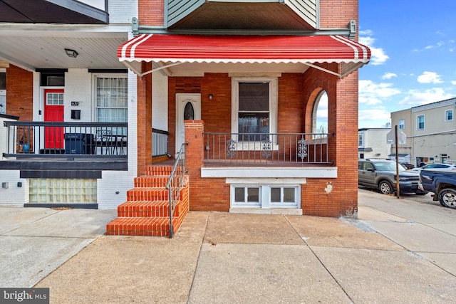639 S Conkling St, Baltimore, MD 21224 - view of front of house featuring brick siding and covered porch