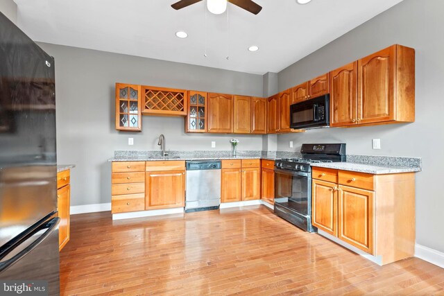 639 S Conkling St, Baltimore, MD 21224 - kitchen with freestanding refrigerator, dishwasher, a sink, baseboards, and glass insert cabinets