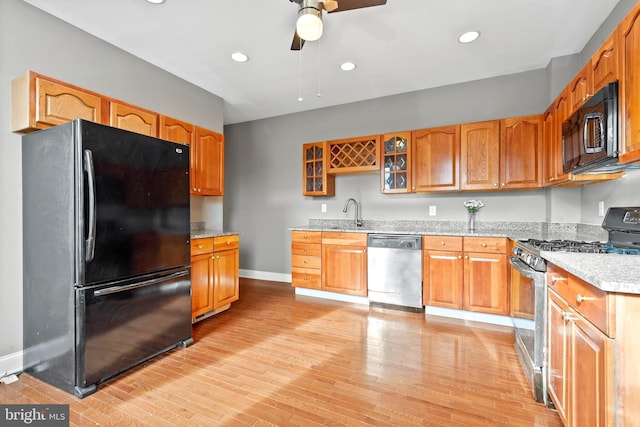 639 S Conkling St, Baltimore, MD 21224 - kitchen featuring black appliances, baseboards, ceiling fan, glass insert cabinets, and light wood-type flooring