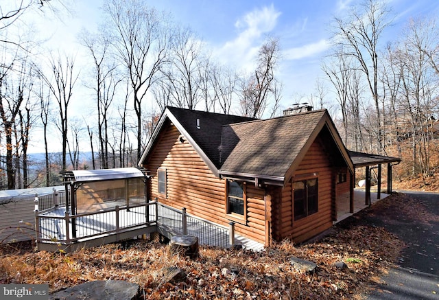 view of side of property featuring a deck