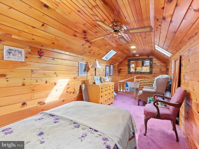 bedroom with wood walls, wooden ceiling, vaulted ceiling with skylight, ceiling fan, and carpet floors