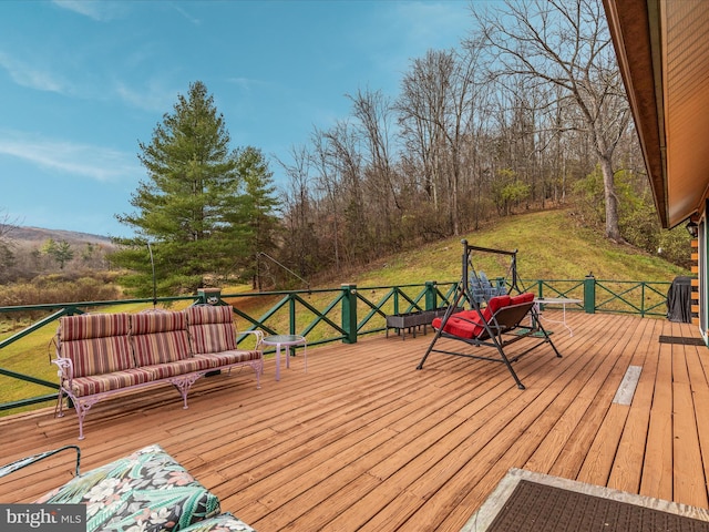 wooden deck featuring a yard