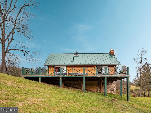 back of property with a lawn and a wooden deck