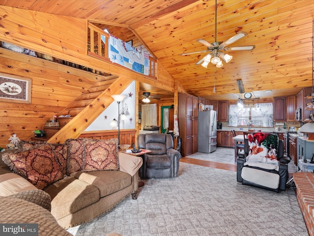 living room with wood walls, wood ceiling, and high vaulted ceiling