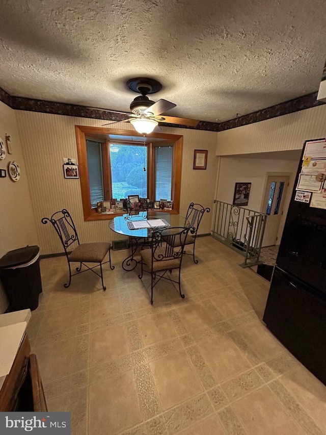 dining room featuring a textured ceiling and ceiling fan