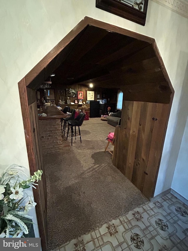 interior space with wood walls and carpet floors