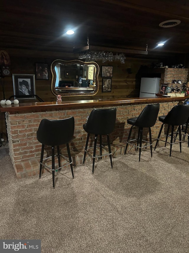 bar with carpet and white fridge