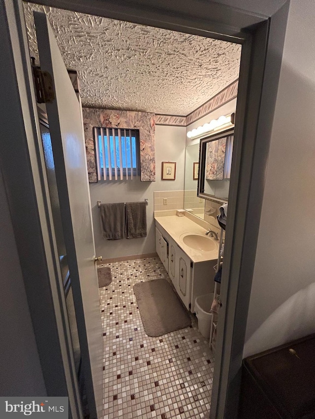 bathroom featuring tile patterned flooring and vanity