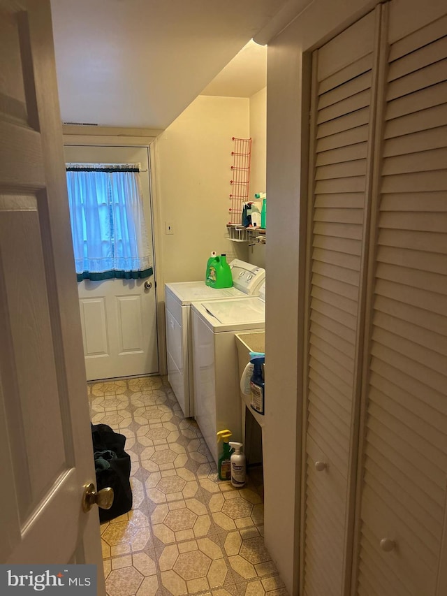 clothes washing area with washer and dryer