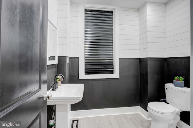 bathroom with hardwood / wood-style floors and toilet