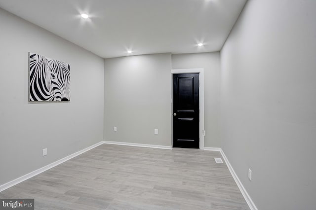 spare room featuring light hardwood / wood-style flooring