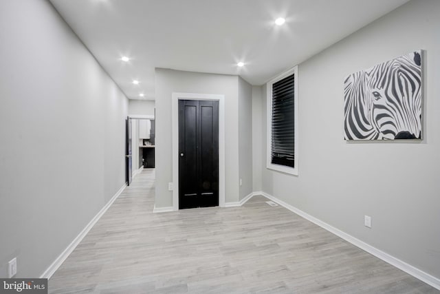 hallway with light hardwood / wood-style flooring