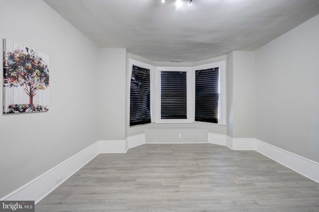 empty room with light hardwood / wood-style floors