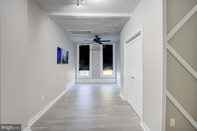 corridor with light hardwood / wood-style floors