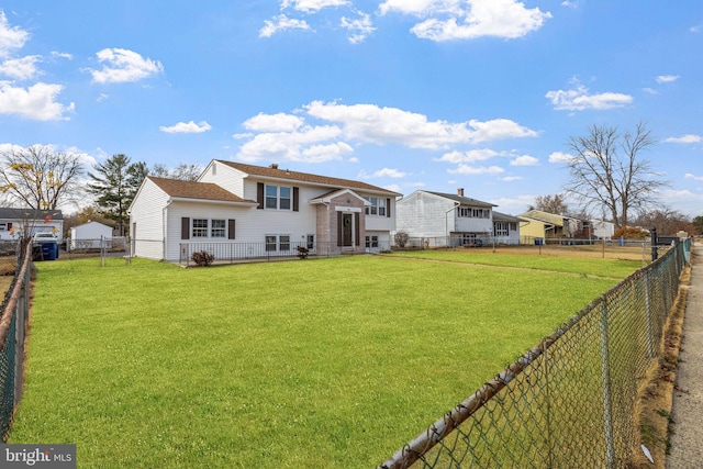 back of house with a lawn