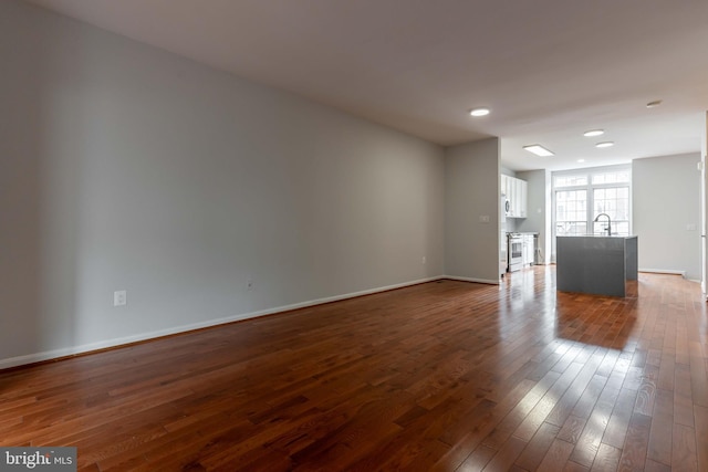 unfurnished living room featuring dark hardwood / wood-style flooring