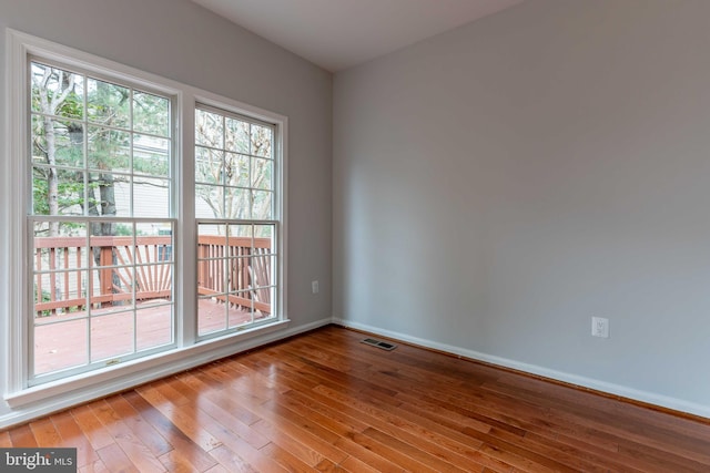 empty room with hardwood / wood-style flooring