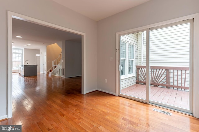 spare room featuring wood-type flooring