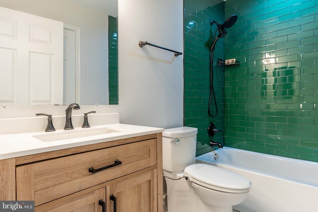 full bathroom featuring vanity, toilet, and tiled shower / bath