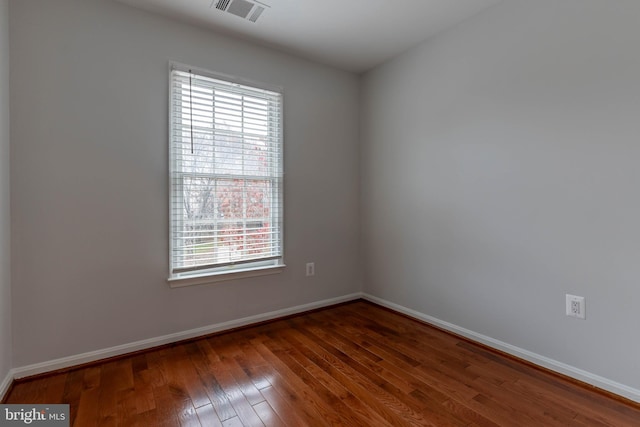 empty room featuring dark hardwood / wood-style flooring