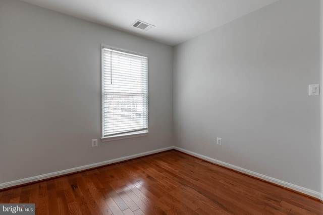 spare room with wood-type flooring