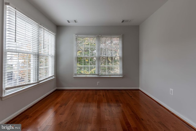 empty room with dark wood-type flooring