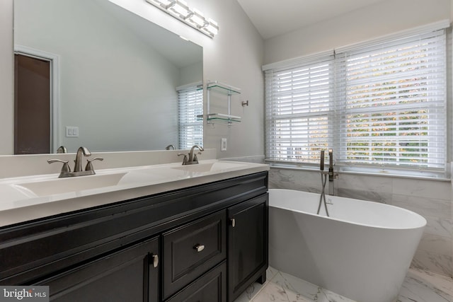 bathroom featuring tile walls, a bathtub, vanity, and lofted ceiling