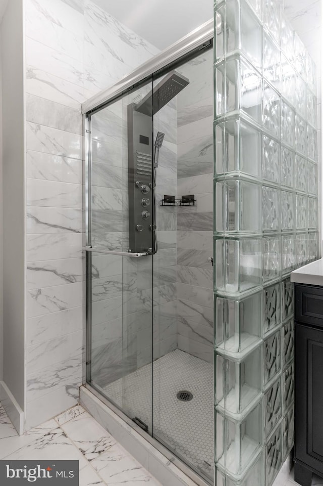 bathroom featuring vanity and a shower with shower door