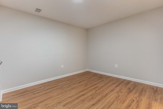 empty room with light hardwood / wood-style flooring