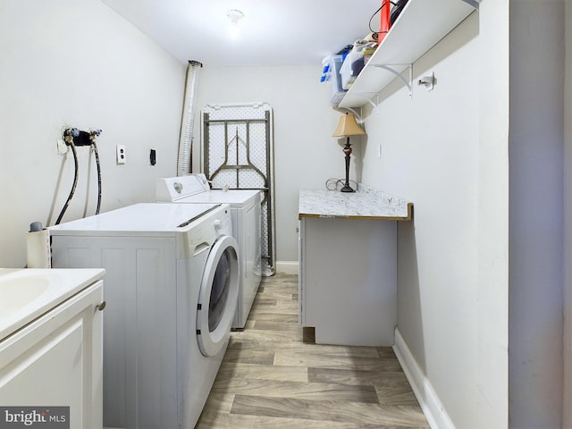 washroom with light wood-type flooring and washing machine and clothes dryer