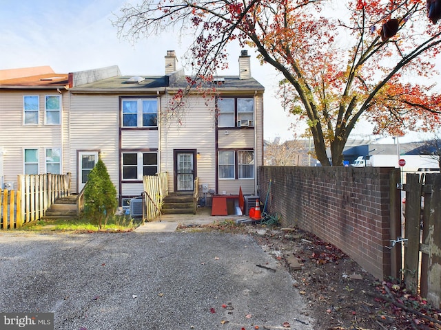 back of property featuring central AC