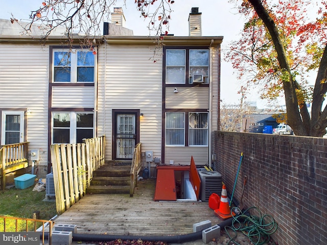 rear view of house with a wooden deck and central AC unit