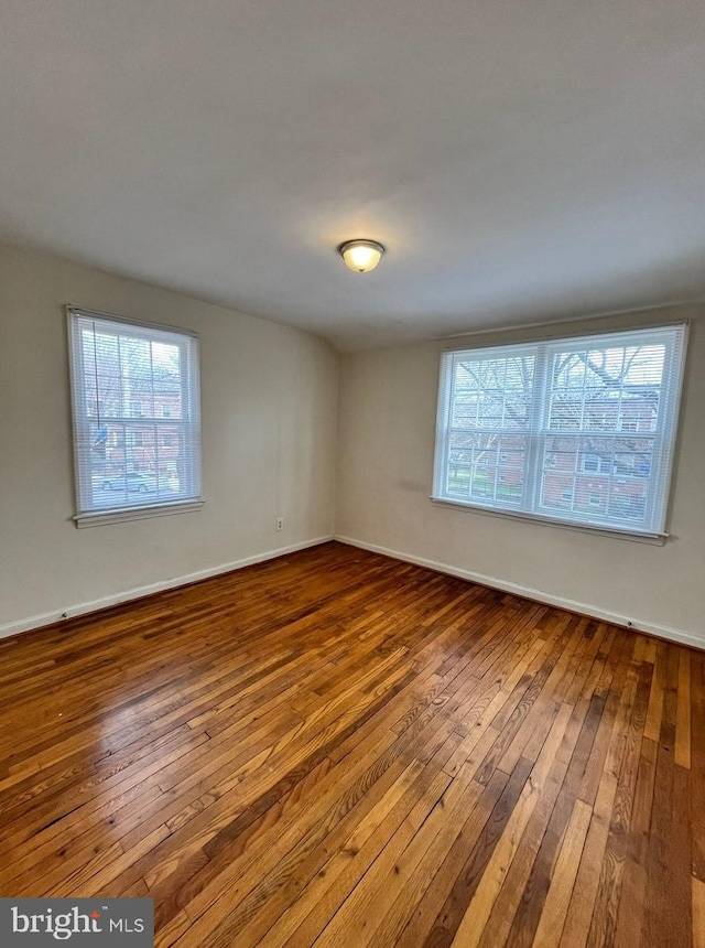 unfurnished room with hardwood / wood-style floors