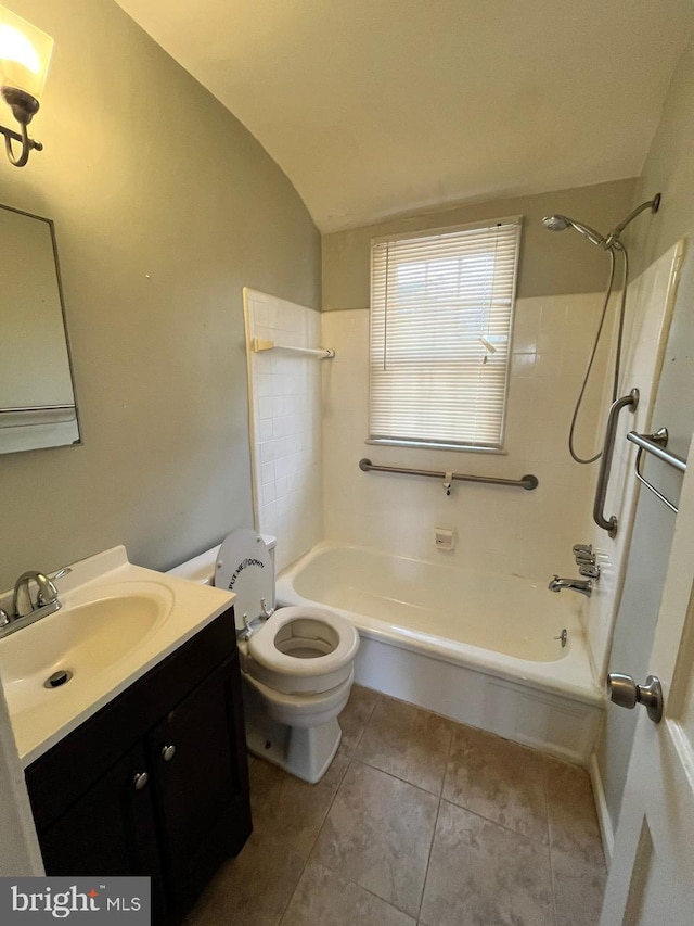 full bathroom with  shower combination, tile patterned floors, vaulted ceiling, and toilet