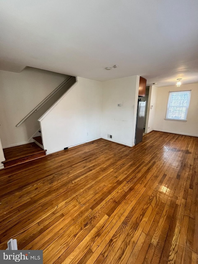 unfurnished living room with wood-type flooring