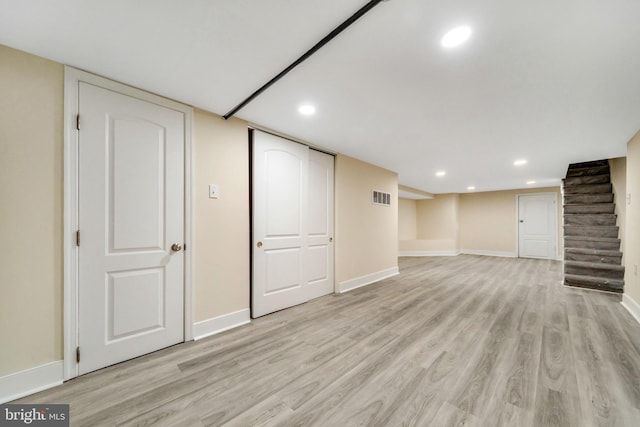 basement featuring light wood-type flooring