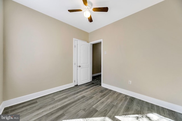 empty room featuring ceiling fan and wood-type flooring