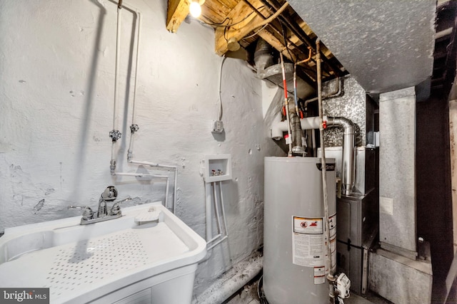 utility room featuring gas water heater and sink