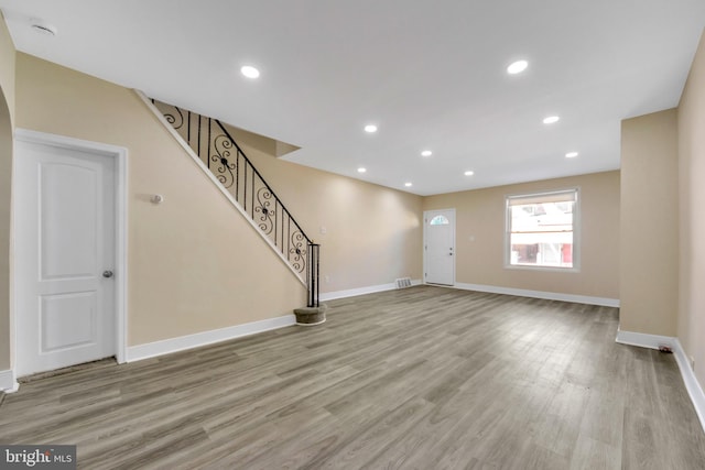 unfurnished living room with light hardwood / wood-style flooring