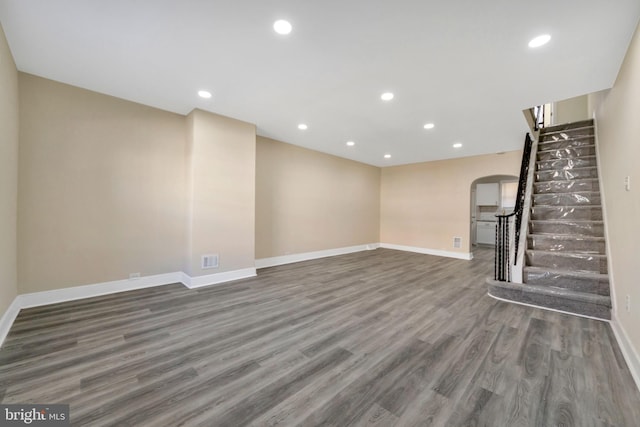 unfurnished living room with dark wood-type flooring