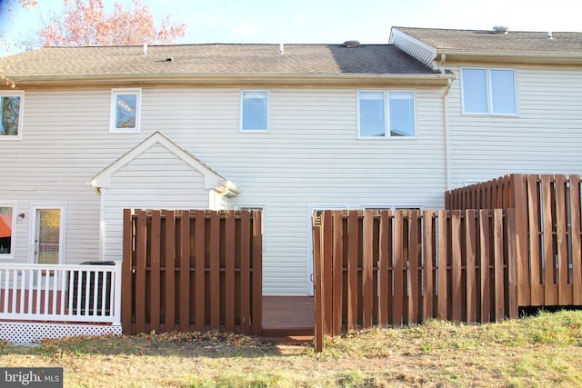 rear view of house featuring a wooden deck