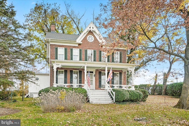 view of front facade with a porch and a front yard