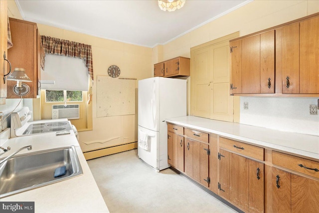 kitchen with white fridge, crown molding, a baseboard heating unit, and sink