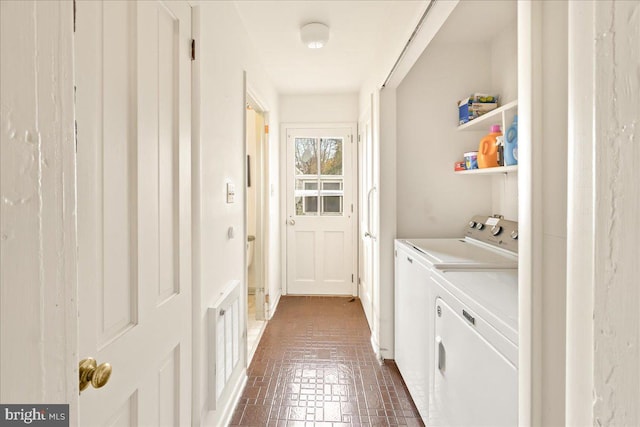 clothes washing area with separate washer and dryer