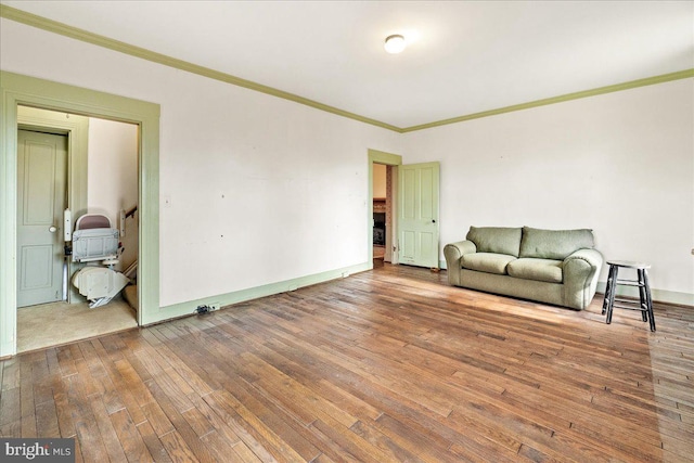 unfurnished room featuring hardwood / wood-style flooring and crown molding