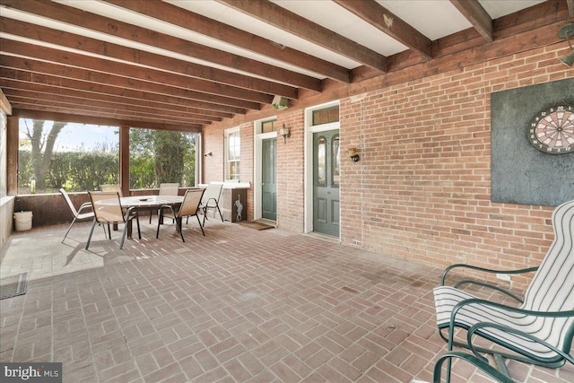 sunroom / solarium featuring beam ceiling