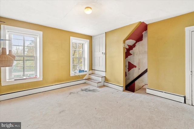 carpeted empty room with a baseboard radiator