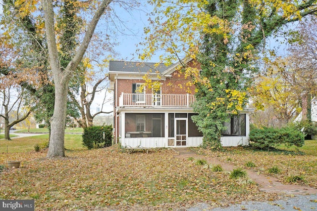 exterior space featuring a sunroom and a balcony