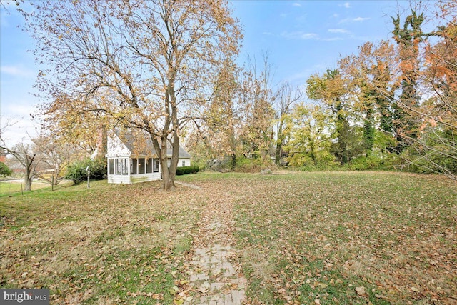 view of yard featuring a sunroom